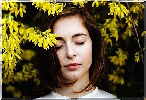 Girl surrounded by yellow flowers, happy to feel good about herself