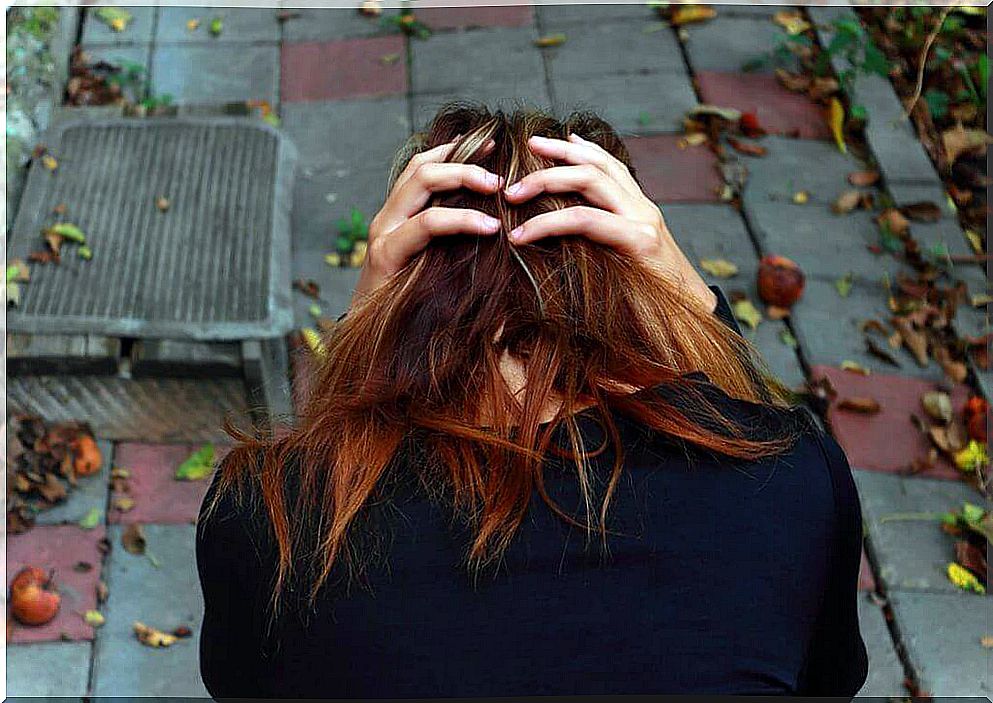 Anxious woman with hands on head