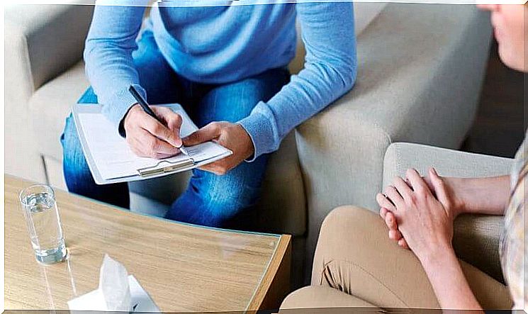 Psychologist taking notes on patient