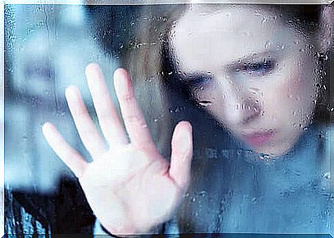 Woman anxiously in front of a window