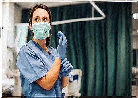 Nurse putting on gloves.