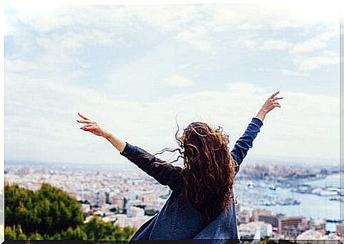 Woman from behind with arms outstretched