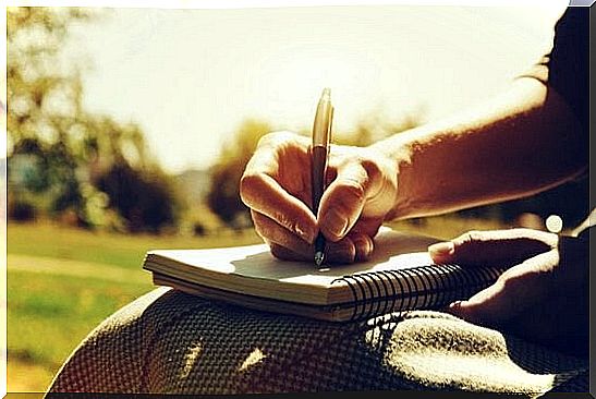 Hand with pen and notebook