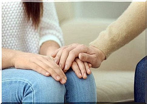 A person who shakes hands with another, a symbol of emotional support to give well-being