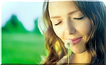 Woman sniffing a flower