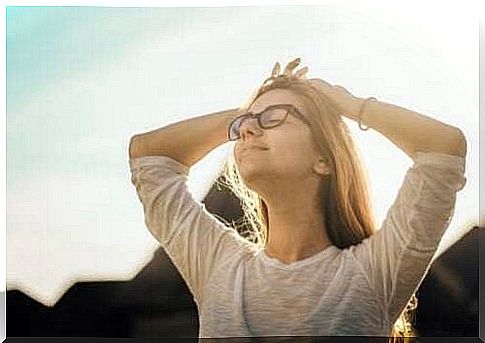 Woman with her face turned to the sun.