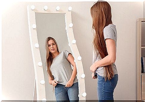 Girl looking in the mirror.