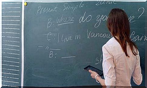 Girl doing an English language exercise at the blackboard.