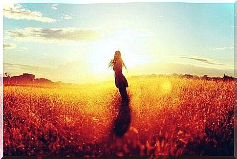 Girl alone in a field trying to live without a family