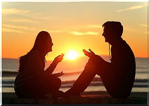 Couple talks at sunset