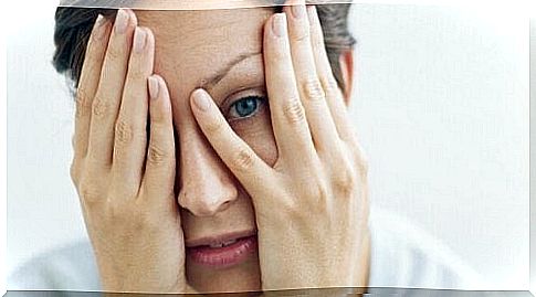 Woman covering her face with her hands