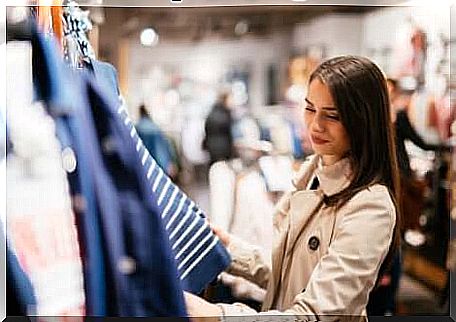 Girl buys conditioning from music in a clothing store.