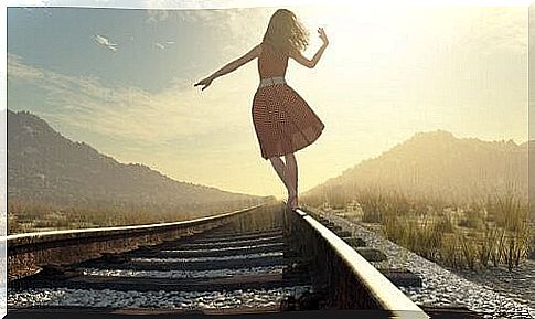 Woman balancing on the tracks