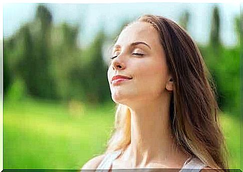 Girl with closed eyes in a meadow.