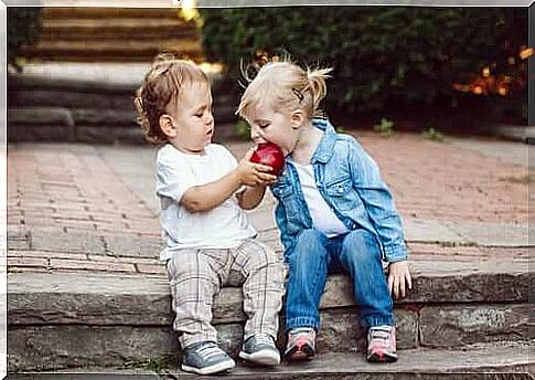 Children sharing an apple