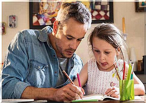 Father and daughter coloring together.