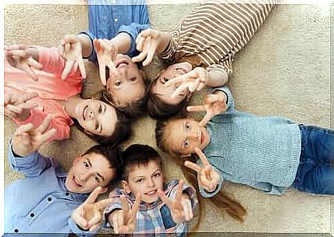 Children playing on the ground in a circle.